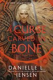 A CURSE CARVED IN BONE TRADE PAPERBACK